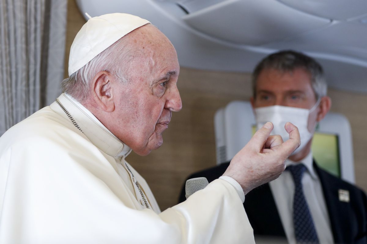 Pope Francis speaks to journalists, Monday, March 8, 2021, while flying back to The Vatican at the end of his four-day trip to Iraq where he met with different Christian communities and Shiite revered cleric Grand Ayatollah Ali al-Sistani. At right pope
