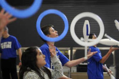
Sergey Grankin, a student at Chase Middle School juggles a set of clubs while Lincoln Heights sixth-grader Breann Bavandpouri tosses rings during practice at Lincoln Heights Elementary. 
 (Dan Pelle / The Spokesman-Review)