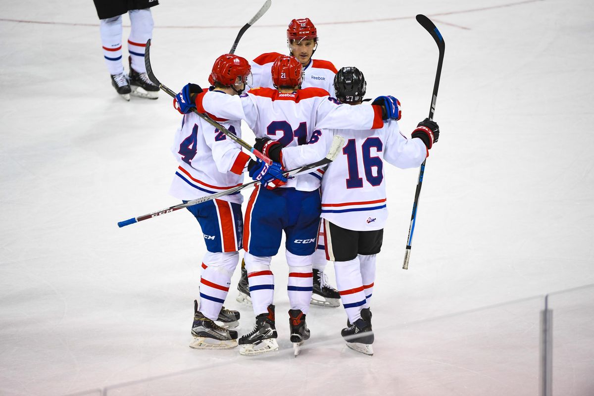 Team White players  celebrate a goal by Bobby Russell (21) during the Spokane Chiefs’ Red-White Game on Aug. 26 in the Arena. (Dan Pelle / The Spokesman-Review)