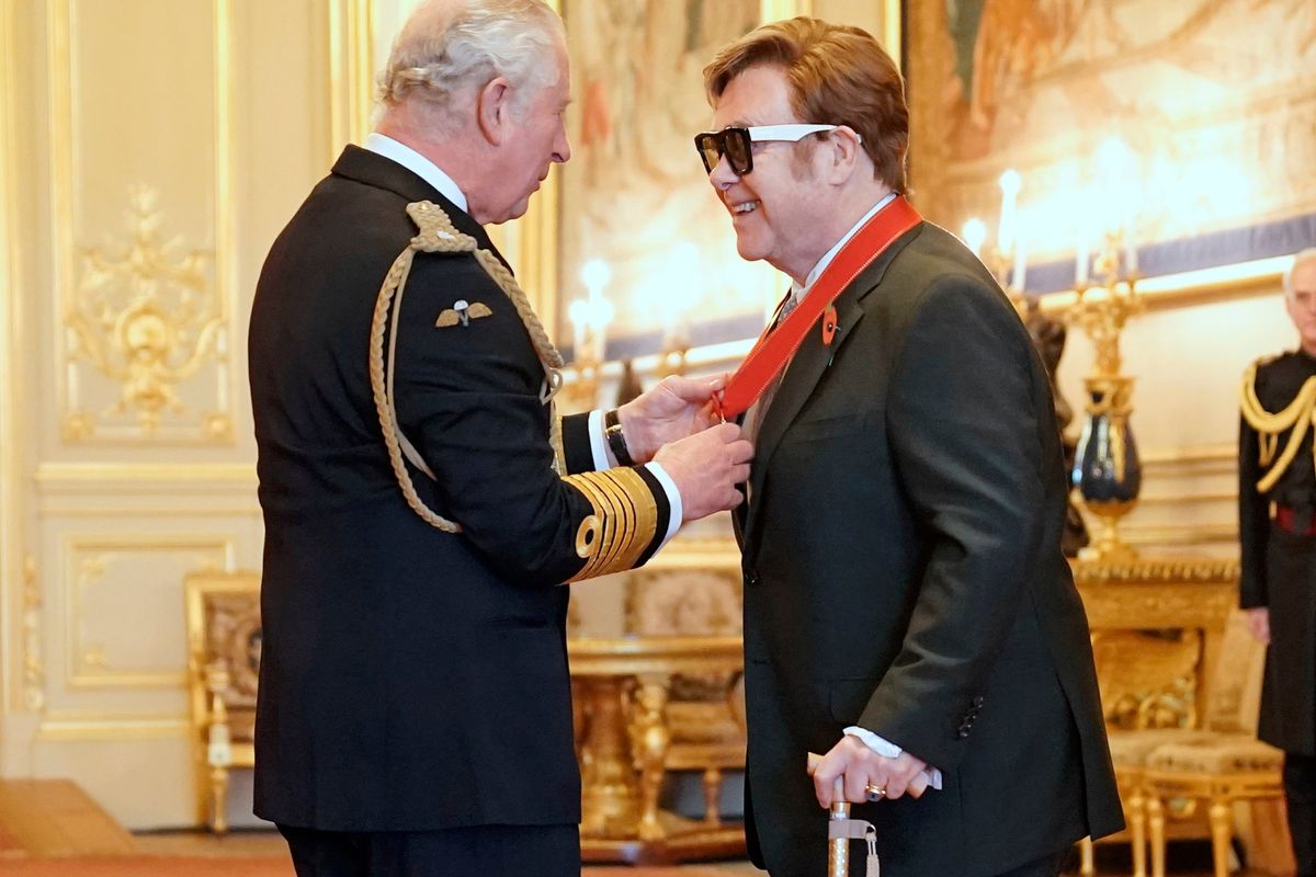 Sir Elton John is made a member of the Order of the Companions of Honour by Prince Charles during an investiture ceremony at Windsor Castle, in Windsor, England, Wednesday, Nov. 10, 2021.  (Aaron Chown)