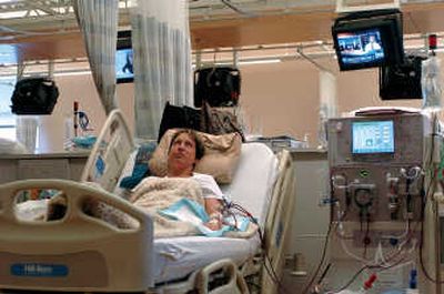 
Surrounded by monitors, Samantha Hewett watches a news show while undergoing kidney dialysis treatment Jan. 18 at Mount Baker Kidney Center in Bellingham.  Last summer, her heart stopped while she was completing dialysis. Medical staff recommended an increasingly common treatment: After her heartbeat was re-established, her body was cooled and she was sedated. Associated Press
 (Associated Press / The Spokesman-Review)