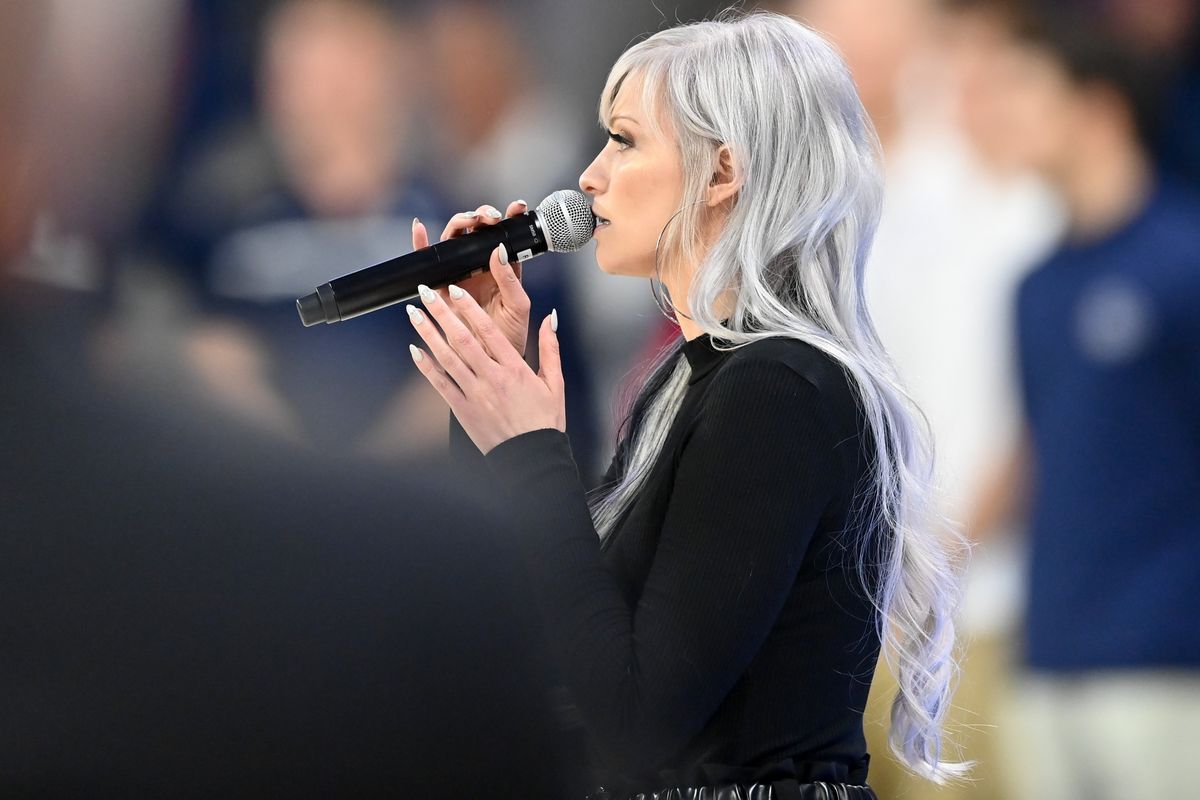 Singer-songwriter Cami Bradley performs the National Anthem at McCarthey Athletic Center on Dec. 9. Bradley, who performs as Carmen Jane with Benn Suede, will be relocating to Los Angeles to pursue their musical careers.  (Tyler Tjomsland/The Spokesman-Review)