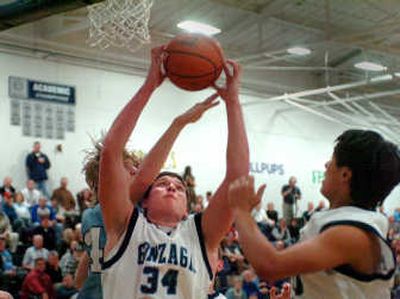 
Gonzaga Prep's Travis Long grabs an offensive rebound away from Central Valley's Alex Howard, rear. At right is Prep's David Nelson.  
 (Jesse Tinsley / The Spokesman-Review)