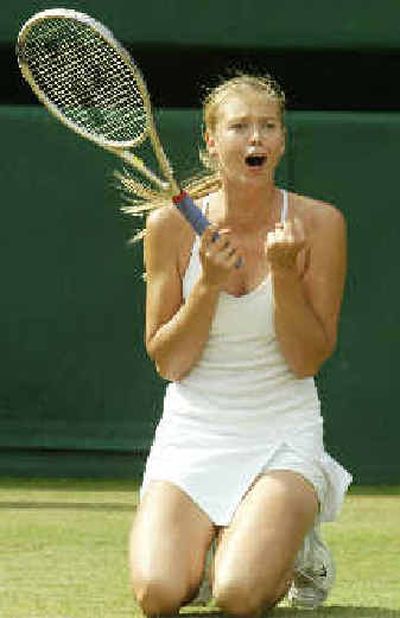 
Russia's Maria Sharapova sinks to her knees, as she defeats Lindsay Davenport in their women's singles semifinal match.  
 (Associated Press / The Spokesman-Review)