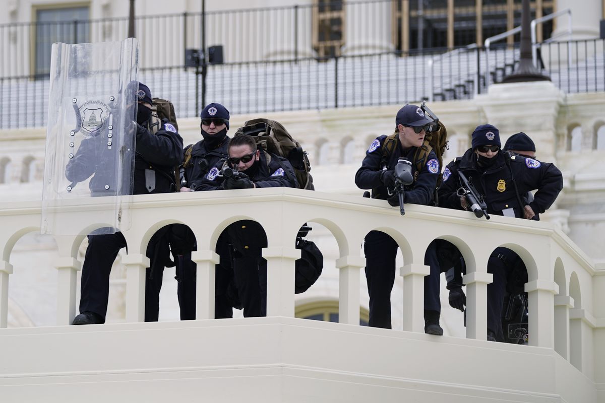 FILE - In this Jan. 6, 2021, file photo, police keep a watch on demonstrators who tried to break through a police barrier at the Capitol in Washington. A blistering internal report by the U.S. Capitol Police describes a multitude of missteps that left the force unprepared for the Jan. 6 insurrection — riot shields that shattered upon impact, expired weapons that couldn’t be used, inadequate training and an intelligence division that had few set standards.  (Associated Press)