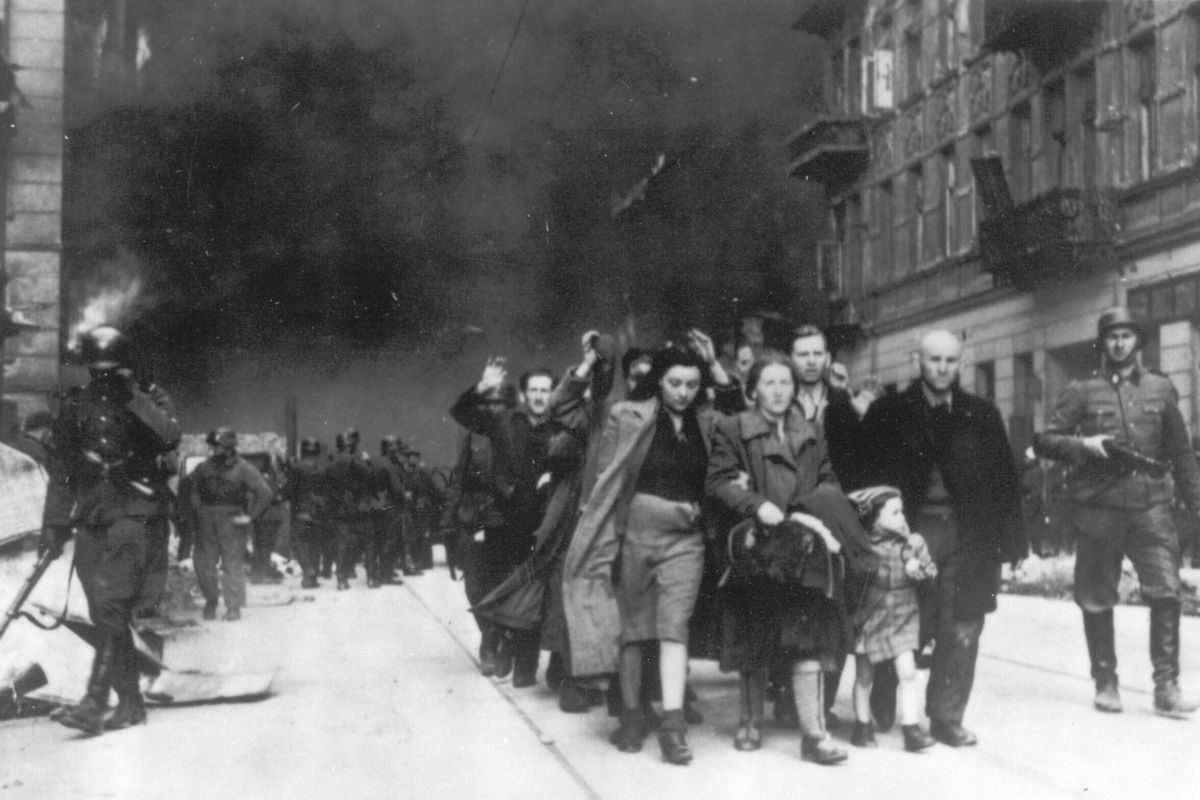 FILE - In this 1943 photo, a group of Polish Jews are led away for deportation by German SS soldiers, during the destruction of the Warsaw Ghetto by German troops after an uprising in the Jewish quarter. Two Polish historians are facing a libel trial for a scholarly examination of Polish behavior during World War II, a case whose outcome is expected to determine the fate of independent Holocaust research under Poland’s nationalist government. A verdict is expected Feb. 9.  (HOGP)