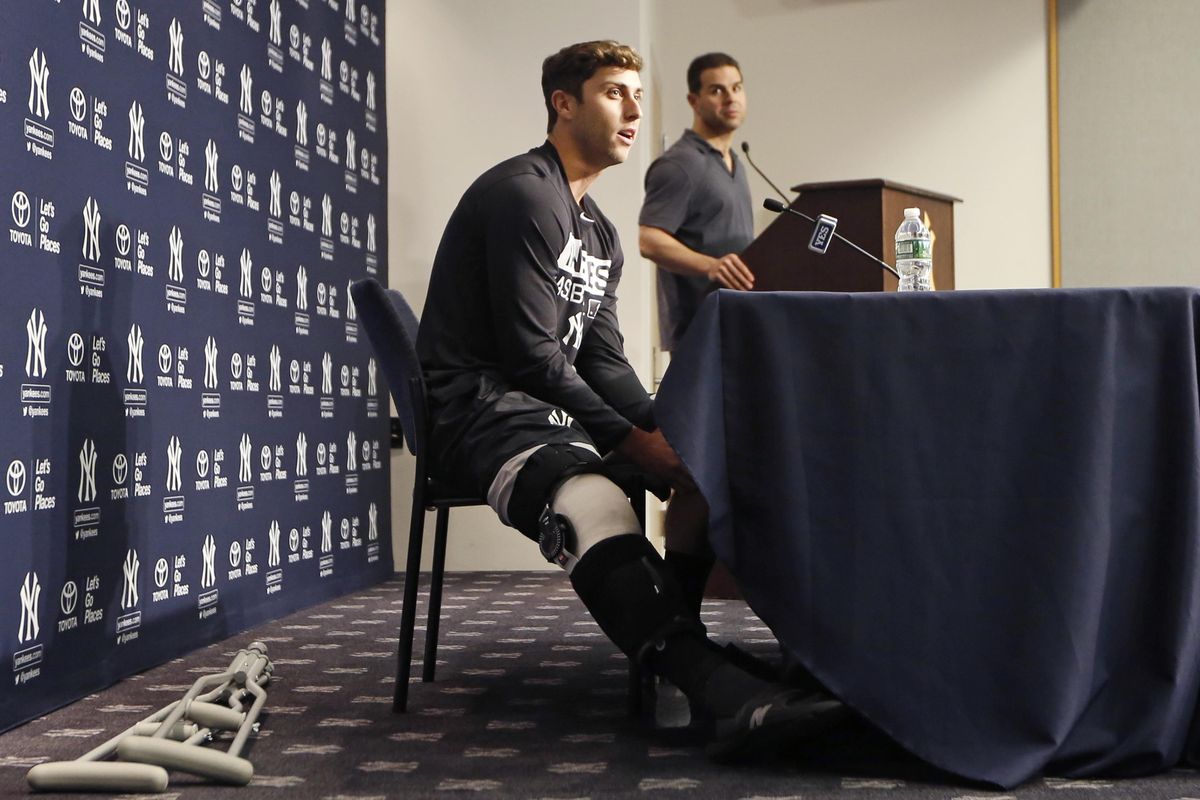 New York Yankees outfielder Dustin Fowler, left, speaks to the media during a press conference at Yankee Stadium in New York, Wednesday, July 5, 2017. Fowler ruptured his right patellar tendon last Thursday after crashing into the outfield wall in the first inning of his major league debut in Chicago. (Kathy Willens / Associated Press)