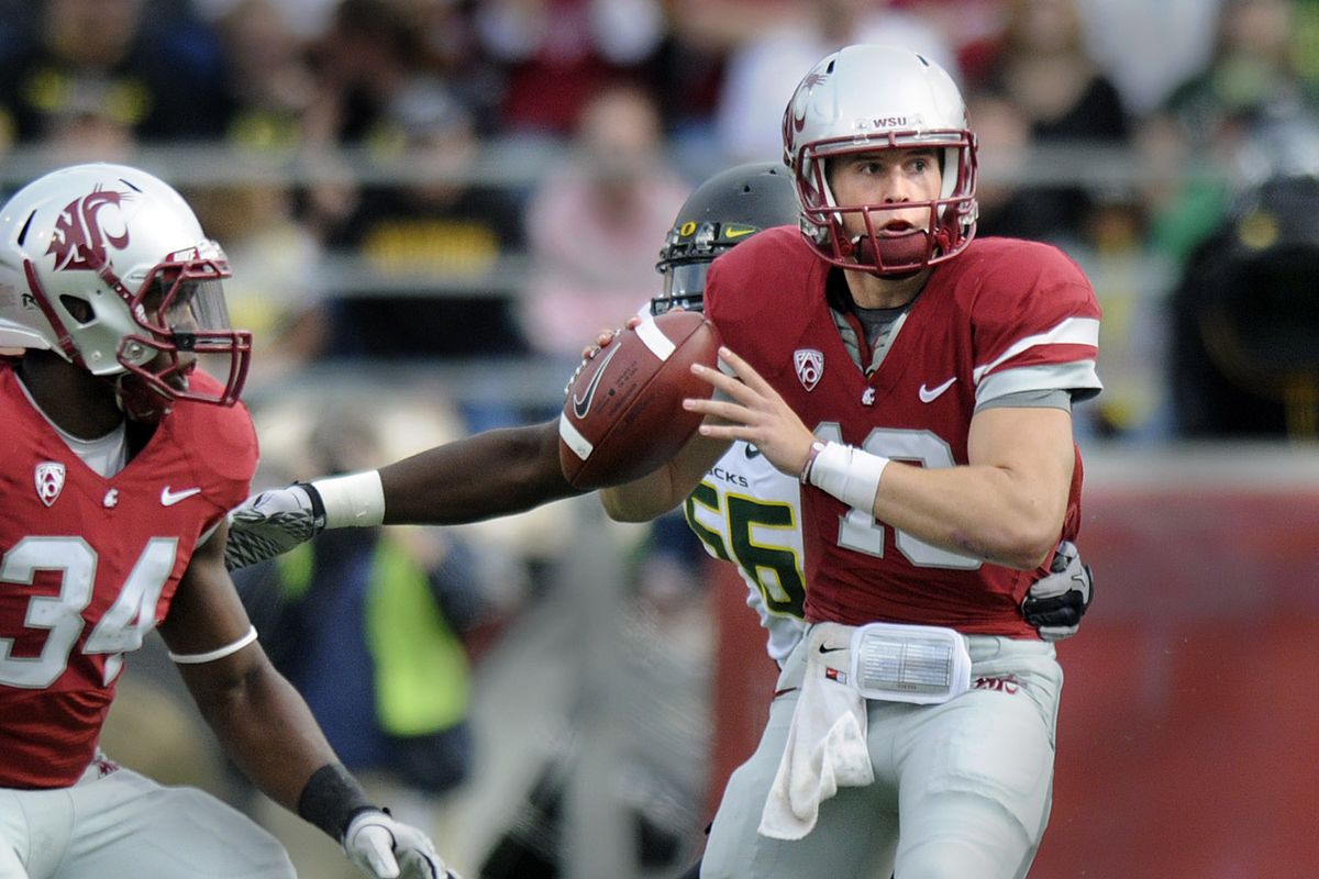 WSU quarteback Jeff Tuel feels the pressure from Oregon defenders as he loks for an open receiver during their game at Martin Stadium in Pullman, Wash. Saturday  October 9, 2010. (Christopher Anderson / The Spokesman-Review)