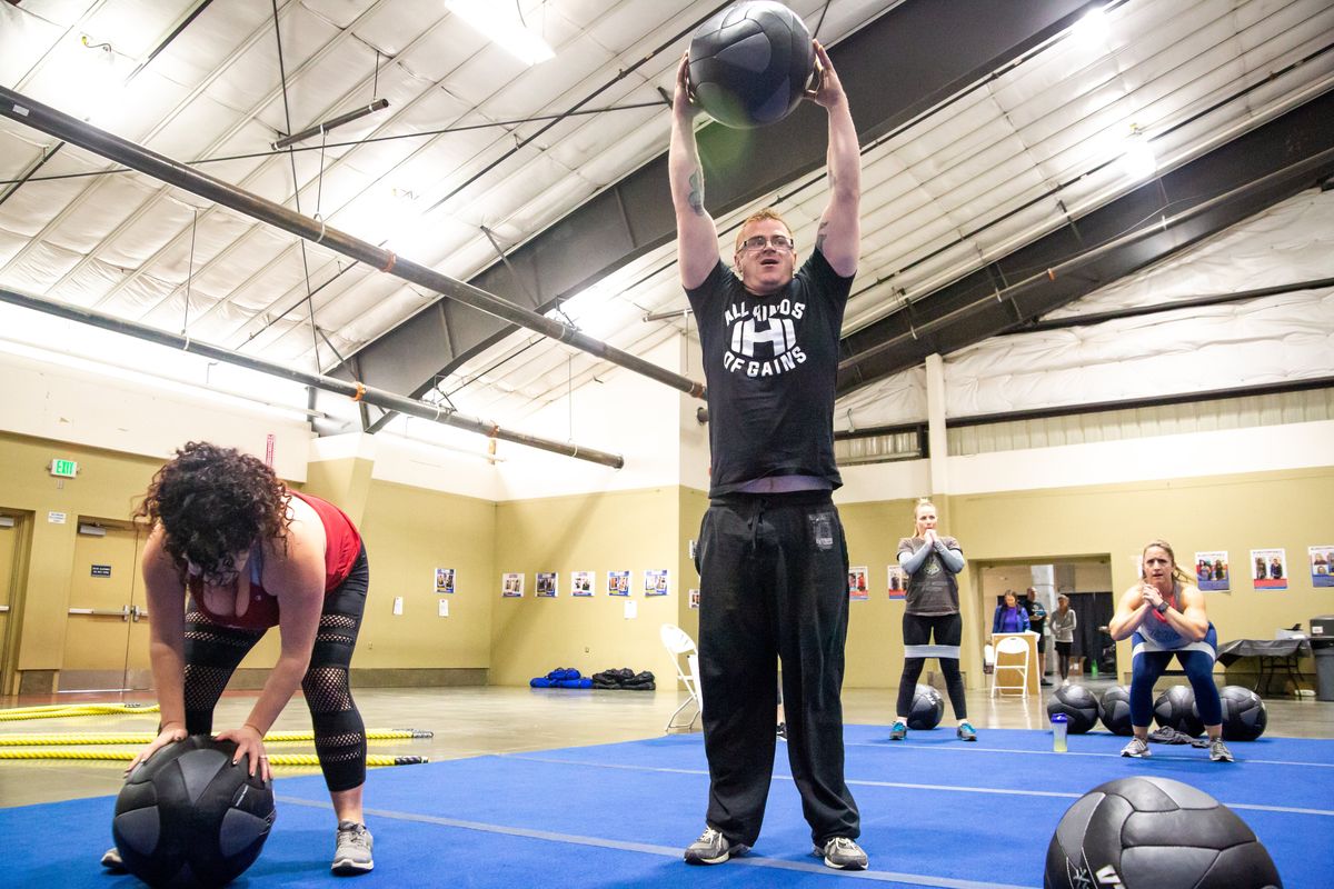Kali Butler and Chris Jordan do slam balls and pushups as they participate in a clinic by the Fit Body on Jan. 5, 2019, during the Spokane Health and Fitness Expo at the Spokane County Fair and Expo Center in Spokane Valley.  (Libby Kamrowski/The Spokesman-Review)