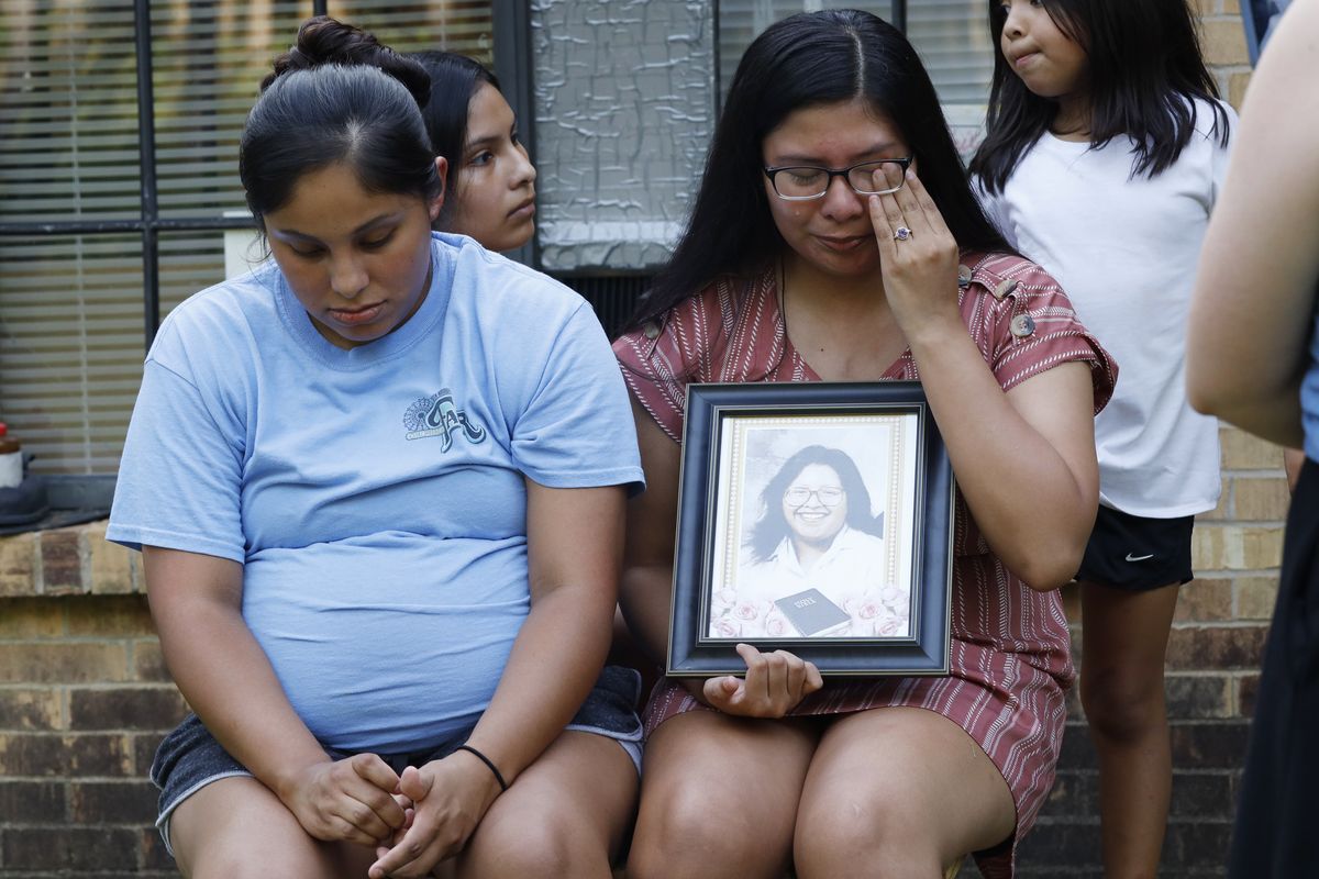Kristina Taylor, 18, cries as she holds a portrait of her late mother, Sharon Taylor, while she and her older sister Kristi Wishork, 25, recall the care their mother had for her children and grandchildren, Tuesday, July 21, 2020 at their home in Tucker, Miss. Taylor, 53, died of coronavirus at the University of Mississippi Medical Center in Jackson on June 26 after two weeks in the hospital. She never saw her daughter Kristina, the class valedictorian at Choctaw Central High School, graduate.  (Rogelio V. Solis)