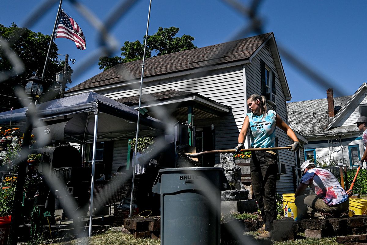 Whitworth sophomore Katelyn Demant, center, works on a front yard makeover at Larry Berringer’s home in West Central on Friday.  (Kathy Plonka/The Spokesman-Review)