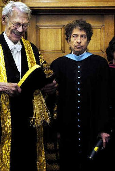 
 Bob Dylan waits on the stage of the University of St Andrews in Scotland, Wednesday, where he received an honorary degree of Doctor of Music from Sir Kenneth Dover, chancellor of the university, left. 
 (Associated Press / The Spokesman-Review)