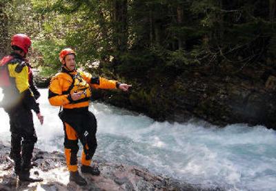 
 James Black and Steve Pugh discuss the best route through a rough section of Slate Creek. 
 (Andy Bright / The Spokesman-Review)