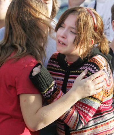 
Memorial Middle School students comfort each other outside the school after the building was evacuated Monday morning. 
 (Associated Press / The Spokesman-Review)