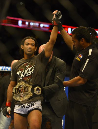 Benson Henderson earned a split decision over Frankie Edgar in the middleweight title bout during UFC 150 Saturday in Denver. (Associated Press)