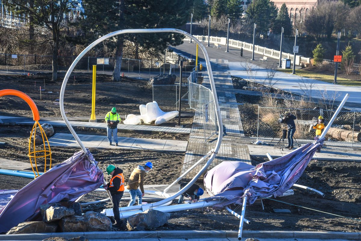 Crews work on the fallen butterfly in Riverfront Park after high winds toppled the structure Wednesday in Spokane.  (DAN PELLE/THE SPOKESMAN-REVIEW)