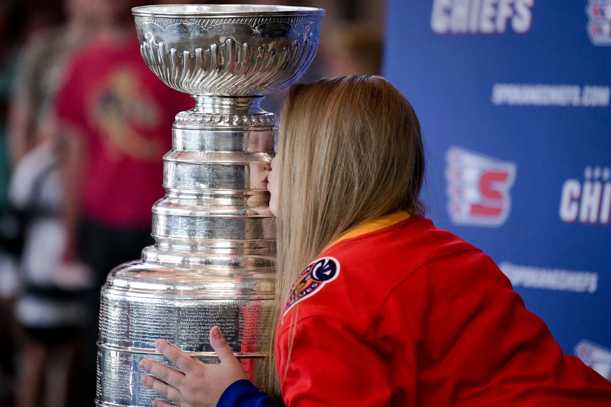 Jessica Lemery of Spokane kisses the Stanley Cup which Tyler Johnson brought to Spokane after he won it as a member of the Tampa Bay Lightning earlier this year, during a celebration event held by the Chiefs on Thursday, July 29, 2021, at Spokane Memorial Arena in Spokane, Wash.  (Tyler Tjomsland/The Spokesman-Review)