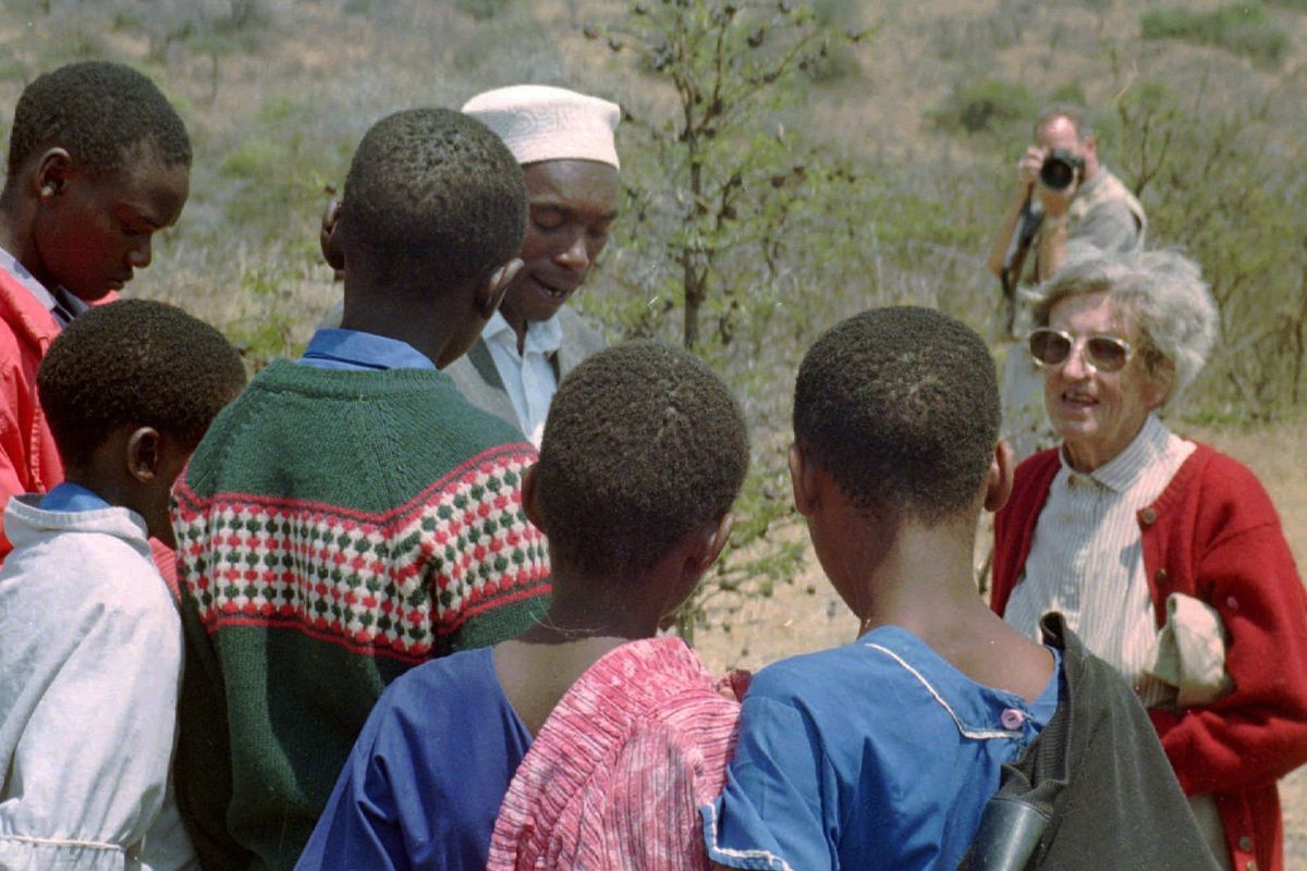 FILE -Archaeologist Mary Leakey speaks to Masai school children on Aug. 16, 1996 at Laetoli, northern Tanzania at the site of 3.6-million-year-old hominid footprints she identified 20 years ago. Prehistoric footprints that have puzzled scientists since the 1970s are getting a second look: Were they left by extinct animals or by human ancestors? When famed paleontologist Mary Leakey first uncovered the footprints in Tanzania 40 years ago, the evidence was ambiguous.  (SUSAN LINNEE)