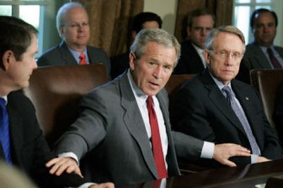 
President Bush, center, speaks Tuesday flanked by Senate Democratic Leader Harry Reid, D-Nev., right, and Senate Majority Leader Bill Frist, R-Tenn., after a meeting  on immigration reform. 
 (Associated Press / The Spokesman-Review)