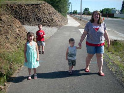 Christina Balcom and her children, from left, Kyleigh, 5, Jesiah, 6, and Dawson, 2, walk on a trail near their neighborhood along Hatch Road. 
 (no photographer / The Spokesman-Review)