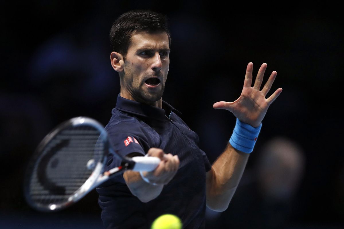 Serbia’s Novak Djokovic plays a return to Japan’s Kei Nishikori during their ATP World Tour Finals doubles semifinal tennis match at the O2 arena in London, Saturday, Nov. 19, 2016. (Kirsty Wigglesworth / Associated Press)