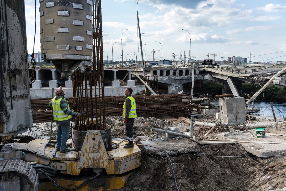 Workers place a rebar frame before pouring a concrete pylon while building the replacement for the destroyed Irpin Bridge, which was demolished to stop Russian forces from crossing the Irpin River, in Irpin, Ukraine, April 24, 2023. A Russia deeply enmeshed in the biggest conflict in Europe since World War II dispatched its foreign minister to the United Nations Security Council on Monday to extol the virtues of peace and diplomacy -- but Western diplomats instantly accused Moscow of hypocrisy.   (Brendan Hoffman/The New York Times)