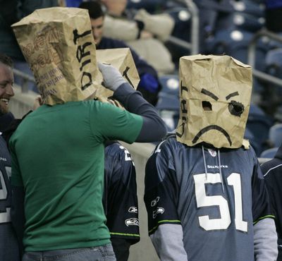 Seattle Seahawks fans wear bags over their heads in the final minutes of Seattle's 24-7 loss to the Tampa Bay Buccaneers in an NFL football game Sunday, Dec. 20, 2009, in Seattle. (John Froschauer / Fr74207 Ap)