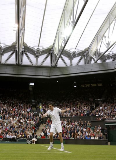 Tim Henman returns a shot under Wimbledon’s new Centre Court roof. (Associated Press / The Spokesman-Review)
