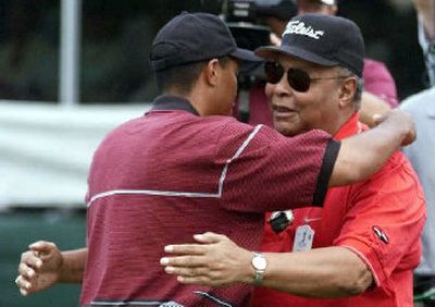 
Earl Woods, right, who was the role model, architect and driving force behind Tiger Woods' career, died Wednesday.
 (Associated Press / The Spokesman-Review)