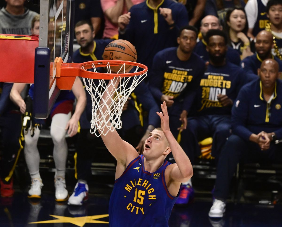 Denver’s Nikola Jokic, who finished with 27 points, scores on a first-quarter layup Thursday against visiting Miami.  (Tribune News Service)