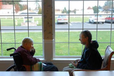 
Berthie Cristie, left, chats with Coeur d'Alene Charter School student Chelsia McNee at her assisted-living home in Coeur d'Alene. The Charter School sixth-grader was part of a penpal group that has been corresponding with the residents of the assisted-living center where Christie lives. 
 (Jesse Tinsley / The Spokesman-Review)