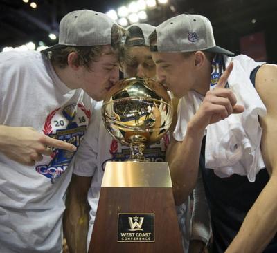 Left to right, Gonzaga forward Kyle Wiltjer , Gonzaga guard Eric McClellan and Gonzaga guard Kyle Dranginis kiss the WCC trophy, Tues., March 8, 2016, at the Orleans Arena in Las Vegas. (Colin Mulvany/SR)