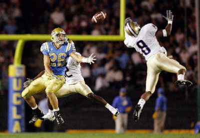 
UW's Dashon Goldson, right, tips a pass intended for UCLA's Joe Cowan. 
 (Associated Press / The Spokesman-Review)