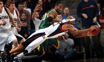 
Erroll Knight goes horizontal to haul in a loose ball against San Francisco on Monday night. Knight had a key defensive play near the end to help GU win 75-72.  
 (Jed Conklin / The Spokesman-Review)
