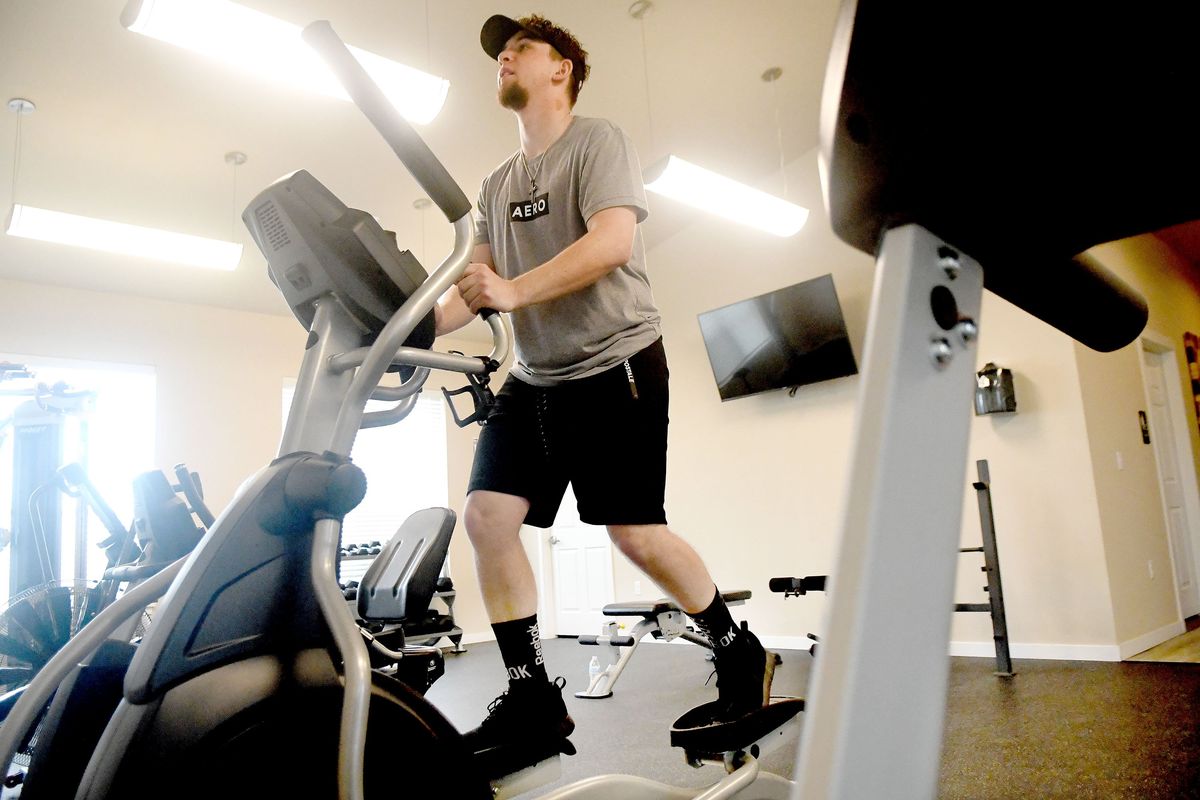 Stephen LeBlanc works out in the gym near at his home in Airway Heights on Wednesday, March 30, 2022. He was shot and paralyzed in 2020. Doctors told him that he would never walk again, now he