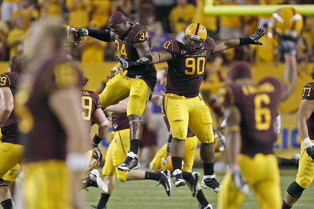 Arizona State’s William Sutton (90) and James Brooks celebrate win over Washington. (Associated Press / The Spokesman-Review)
