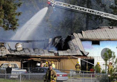 
Spokane Valley fire crews pour water through the collapsed roof of Savage Land Pizza at Fourth and Dishman on Monday. The two-alarm fire broke out about 3:30 a.m. and destroyed the building. 
 (CHRISTOPHER ANDERSON / The Spokesman-Review)