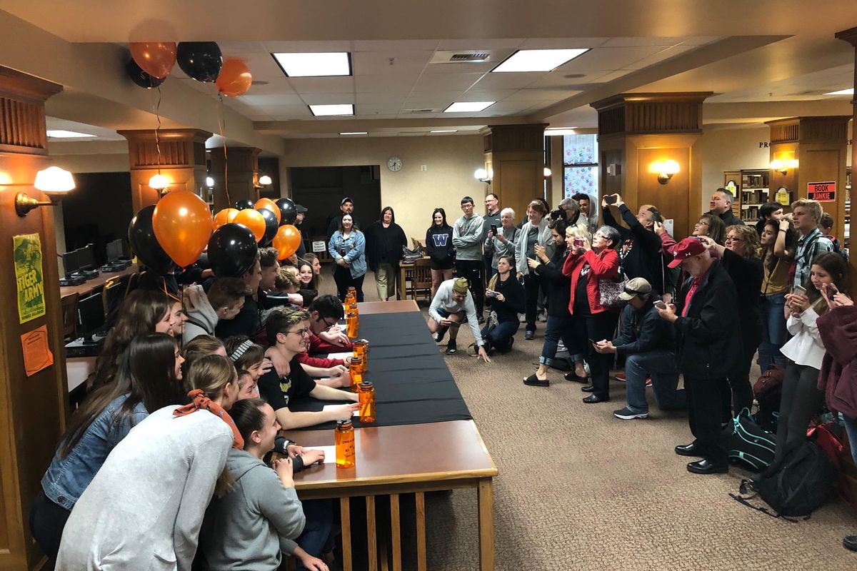 A big crowd gathered as Lewis and Clark seniors signed National Letters of Intent on Wednesday  in the school library. (Dave Nichols / The Spokesman-Review)