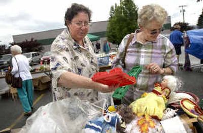 
Mary Ferguson examines a tree-shaped ice cube tray while Susan Roberts looks at other merchandise at a benefit rummage sale for Hayden Stipe, the son of Sheriff's Deputy Steve Stipe and Becky Stipe Saturday. 
 (Holly Pickett / The Spokesman-Review)