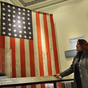 Secretary of State Kim Wyman describes the 42-star flag that's part of the Blazes, Rails and the Year of Statehood exhibit in the state Capital (Jim Camden)