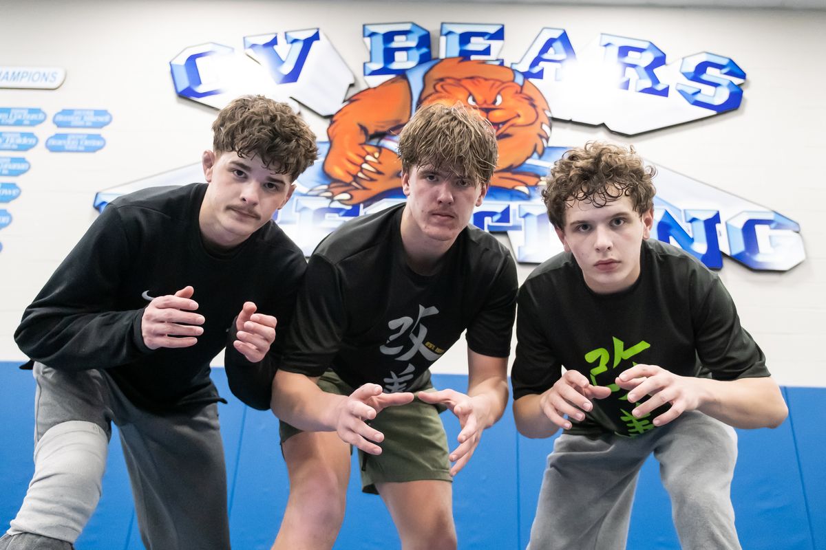 From left, brothers Blaine Beard, Bayden Beard and Braxton Beard pose in the wrestling room Wednesday at Central Valley High School.  (Madison McCord/For The Spokesman-Review)