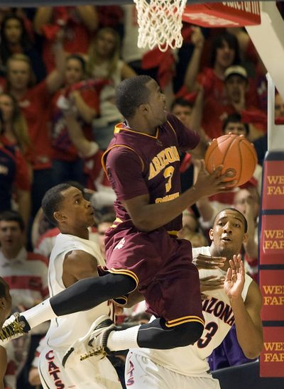 Arizona State’s Ty Abbott shoots over the defense of Arizona’s Derrick Williams.  (Associated Press)