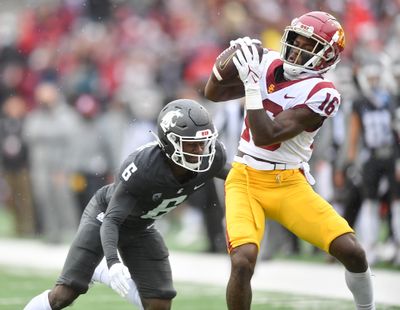 USC wide receiver Tahj Washington, right, hauls in a pass as Washington State cornerback Chau Smith-Wade prepares to make a tackle during a Pac-12 game on Sept. 18, 2021, at Gesa Field in Pullman.  (Tyler Tjomsland/The Spokesman-Review)
