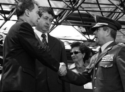 
New head of the Colombian army, Gen. Mario Montoya, right, shakes hands with Colombian President Alvaro Uribe during a military ceremony at a base in Bogota, Colombia, Feb. 22, 2006. 
 (Associated Press photos / The Spokesman-Review)