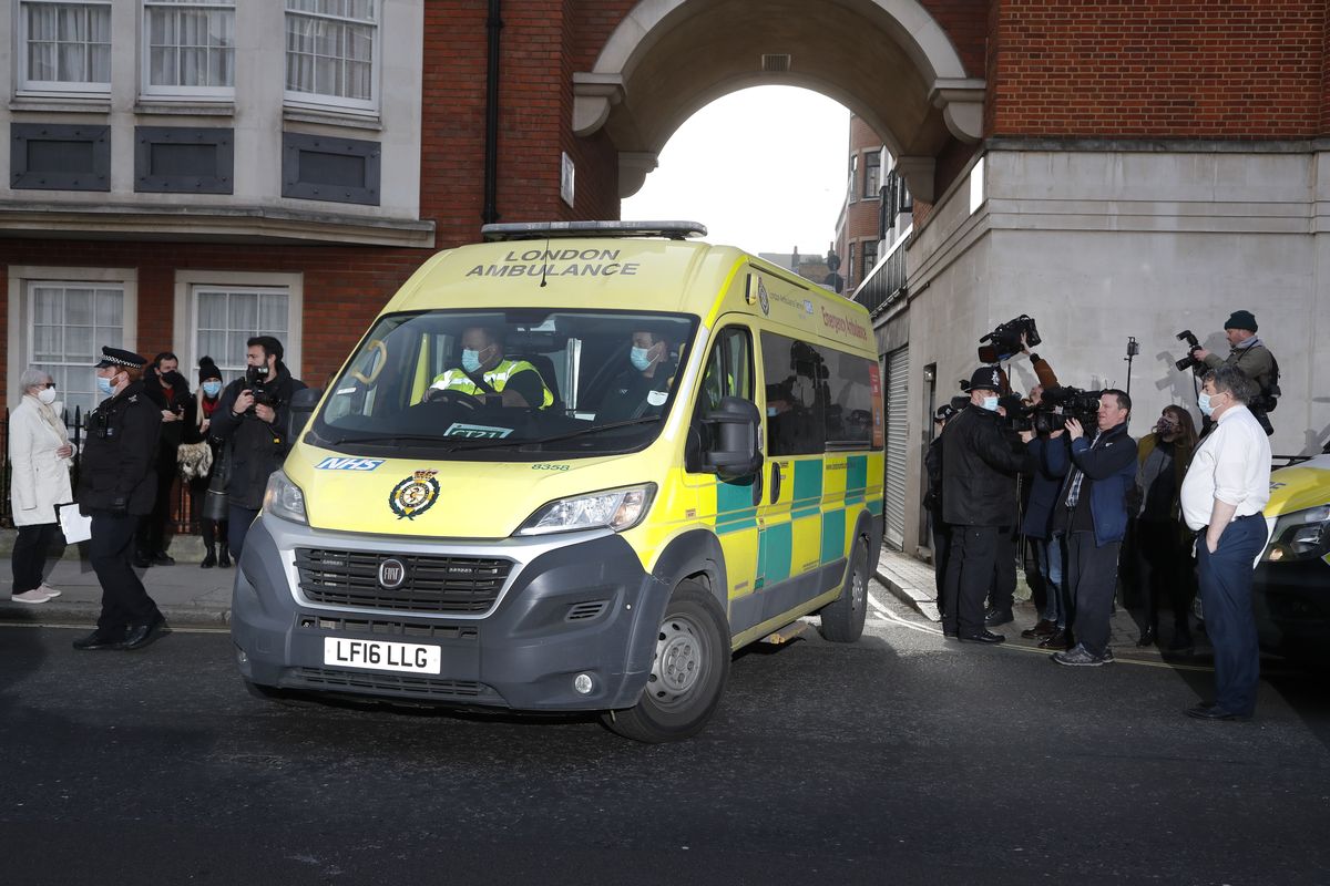 Police officers stand at an entrance to the King Edward VII Hospital where Prince Philip is being treated for an infection, as an ambulance is driven out, in London, Monday, March 1, 2021.  (Frank Augstein)