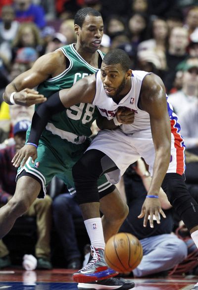 Then-Boston Celtics center Jason Collins, left, guards Detroit Pistons center Greg Monroe in an NBA game Jan. 20. Collins has become the first male professional athlete in the major four American sports leagues to come out as gay. (Associated Press)