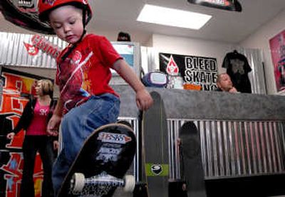 
Three-year-old Bear Brunner works on a few moves at 208SK8, his parents shop in Hayden. His parents are, Jaime, left, and Tony Brunner. 
 (Kathy Plonka / The Spokesman-Review)