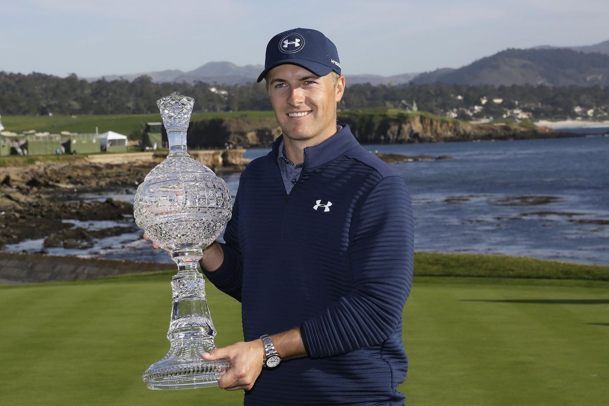 Jordan Spieth poses with his trophy on the 18th green of the Pebble Beach Golf Links after winning the AT&T Pebble Beach National Pro-Am golf tournament Sunday, Feb. 12, 2017, in Pebble Beach, Calif. (Eric Risberg / Associated Press)
