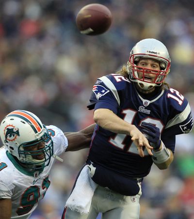 New England Patriots quarterback Tom Brady, right, is All-Pro by unanimous vote. (Associated Press)