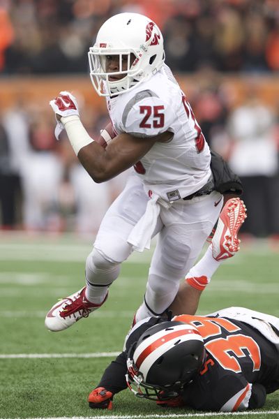Washington State running back Jamal Morrow (25) drives pas Oregon State defender Justin Strong (39) during an NCAA college football game in Corvallis, Ore., Saturday, Nov. 8, 2014. (Troy Wayrynen / Fr32145 Ap)